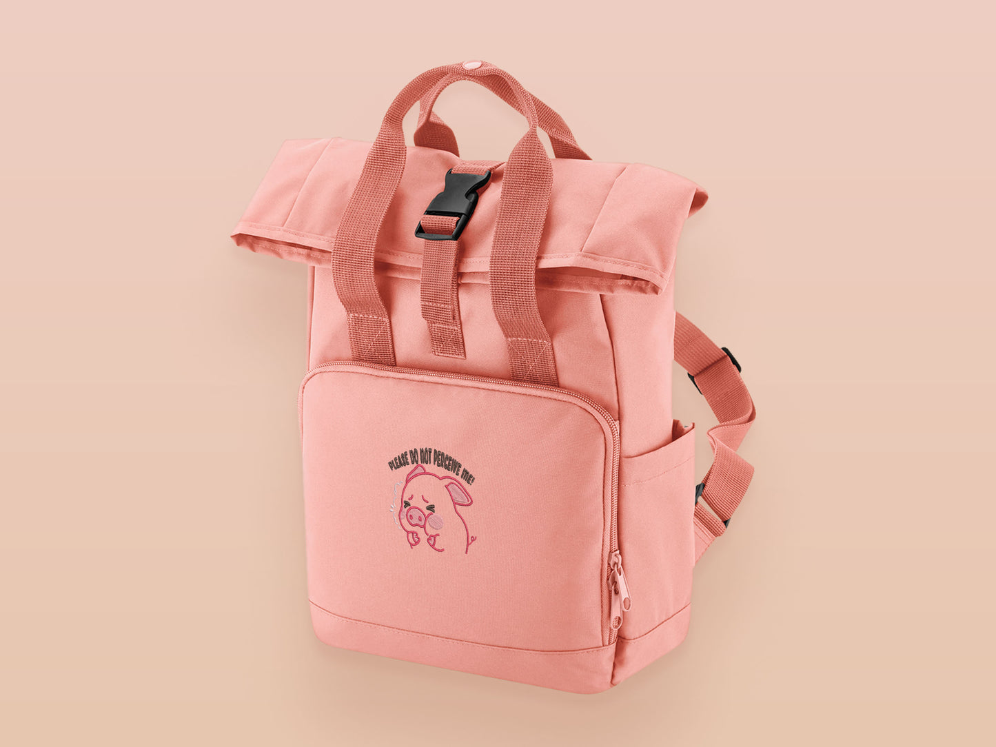 Pink roll top twin handle backpack with an embroided design of cute crying pig and the quote please do not percive me