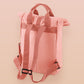 Pink roll top twin handle backpack with an embroided design of cute crying pig and the quote please do not percive me