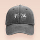 A dark grey baseball cap hat with an embroidered cute white Popcat meme cat design.