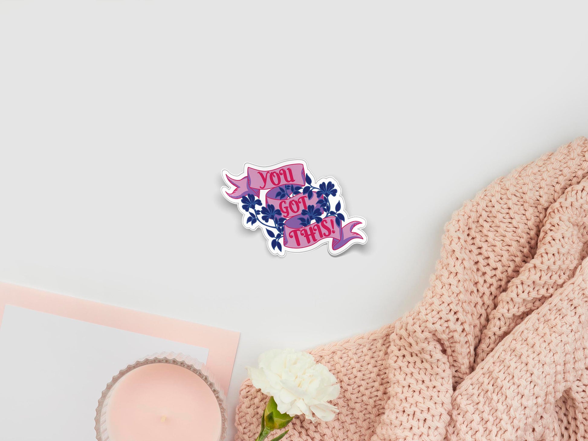 Large sticker of digital illustration cartoon of a purple ribbon with pink text that reads You Got This! surrounded by a navy blue floral pattern