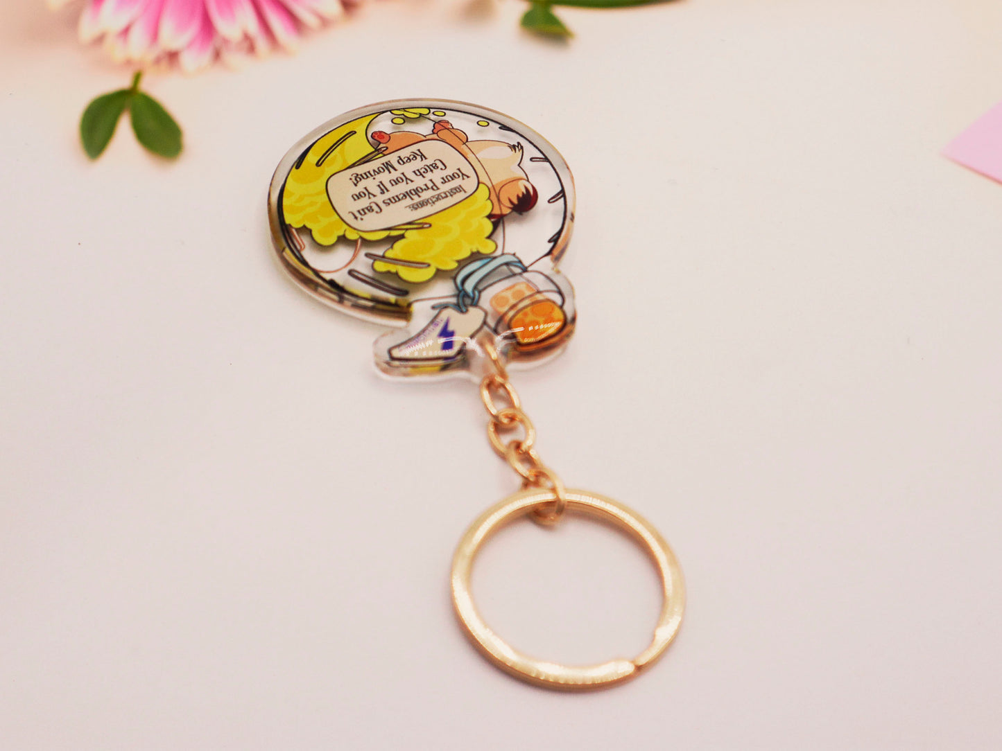 Double sided epoxy keychain with golden clasp of a happy Russian dwarf hamster running in a hamster ball shaped potion bottle labelled potion of speed