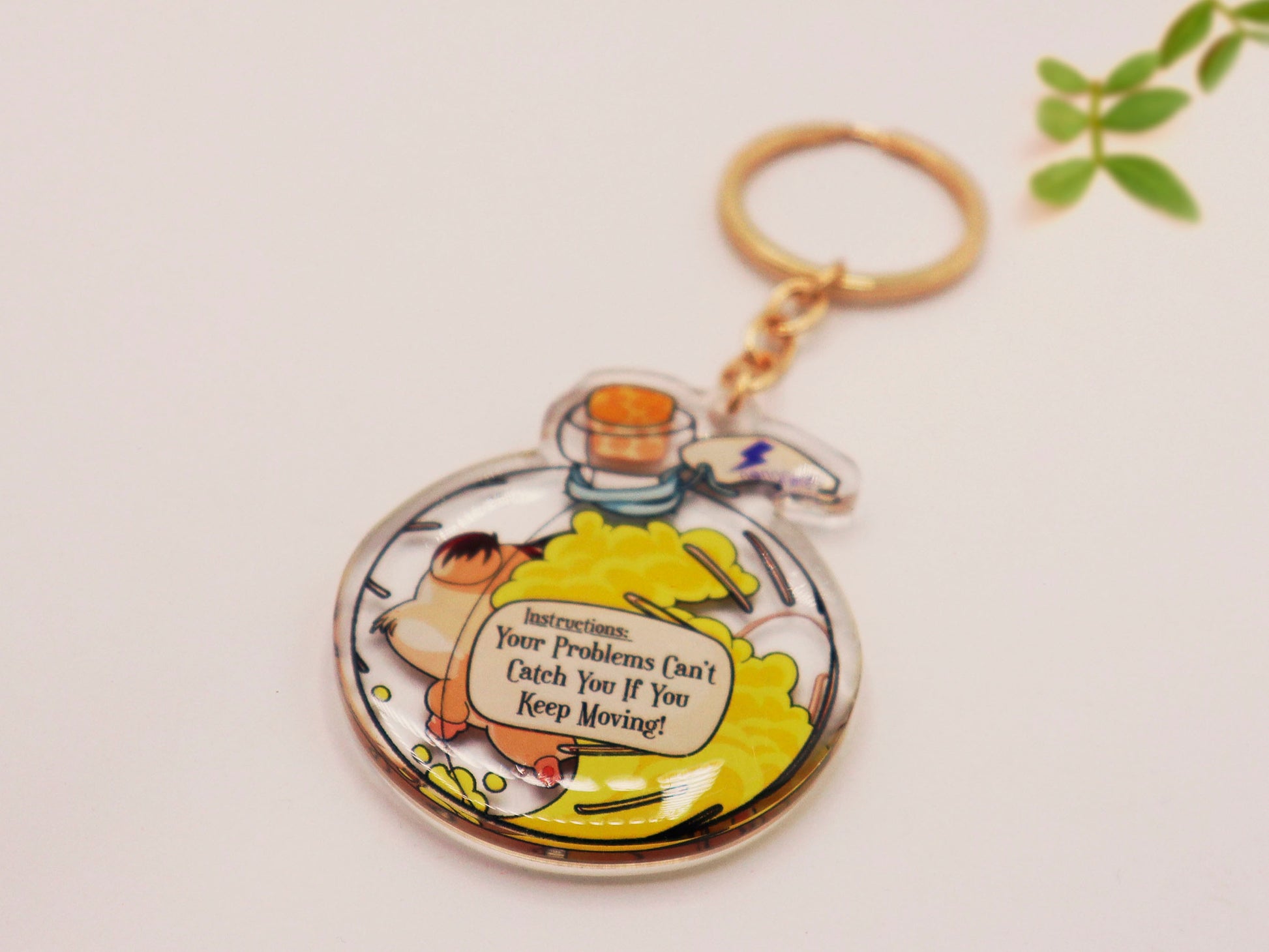 Double sided epoxy keychain with golden clasp of a happy Russian dwarf hamster running in a hamster ball shaped potion bottle labelled potion of speed