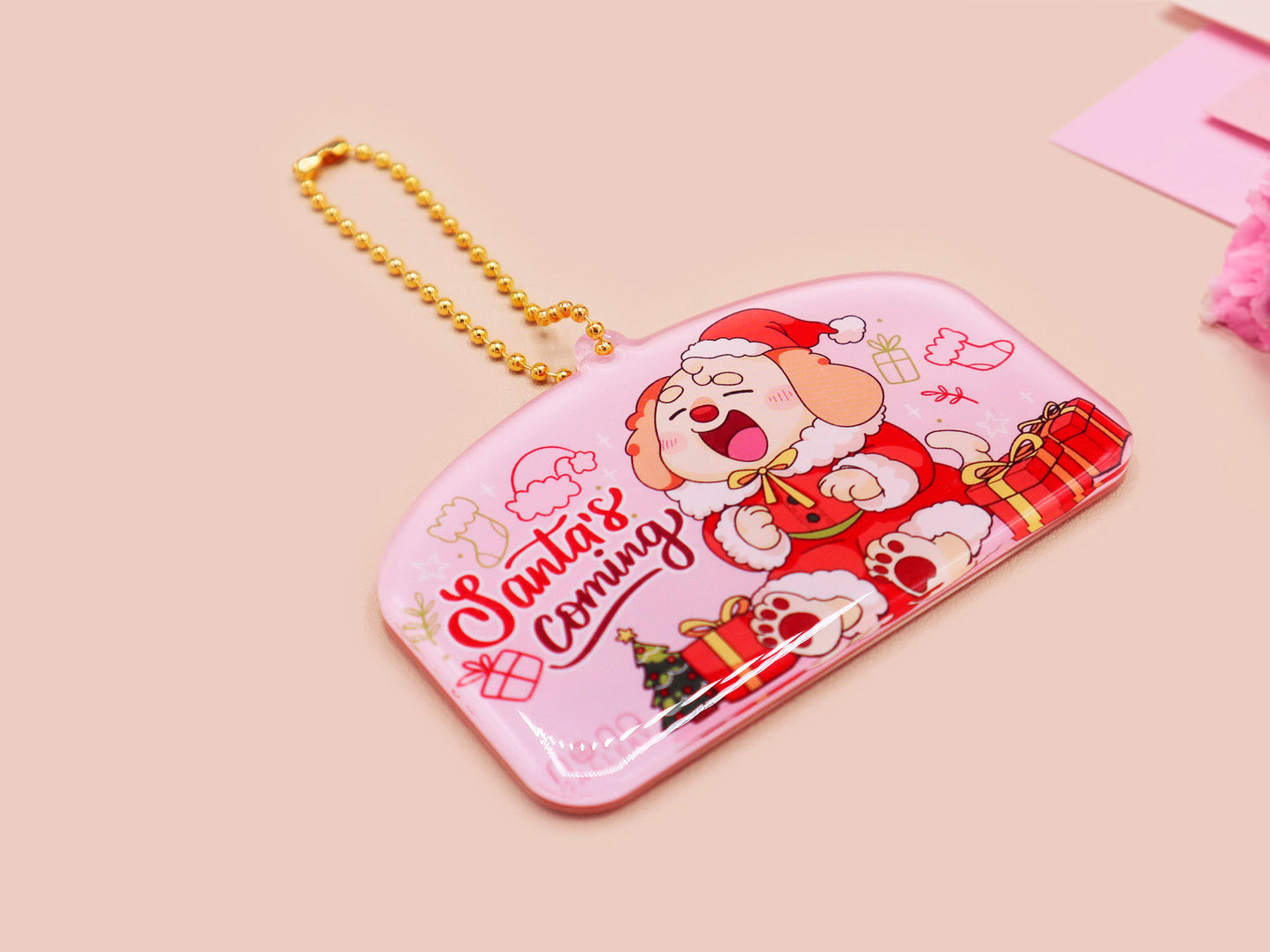 Acrylic epoxy christmas tree hanging decoration with a large acrylic charm of a cute cockapoo barley dog in a santa outfit surrounded by presents with the quoteSanta's coming