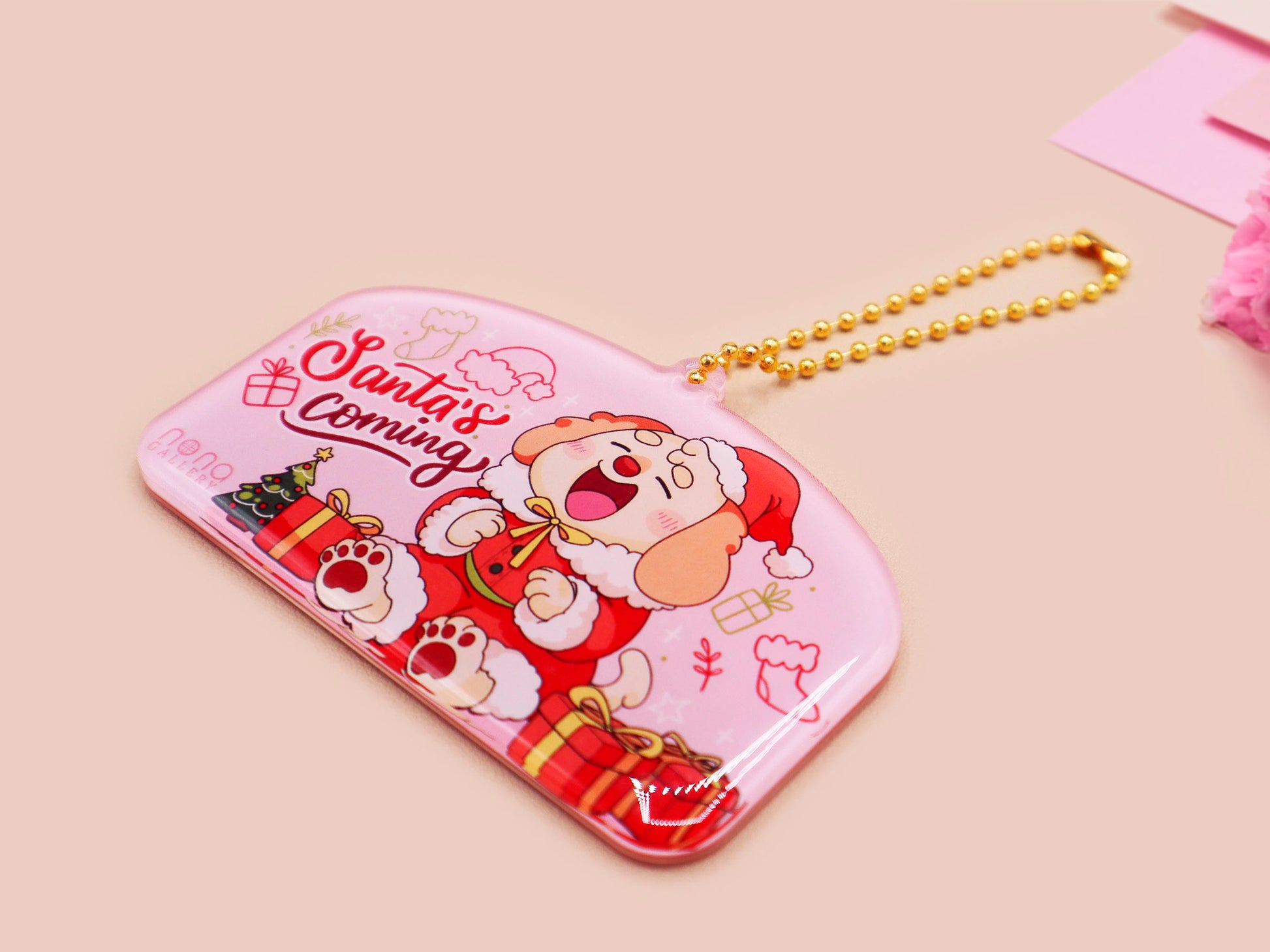 Acrylic epoxy christmas tree hanging decoration with a large acrylic charm of a cute cockapoo barley dog in a santa outfit surrounded by presents with the quoteSanta's coming