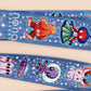 Cute full legth dark blue lanyard with a double sided cryptid monster and alien pattern and silver swivel hook clasp.