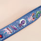 Cute full legth dark blue lanyard with a double sided cryptid monster and alien pattern and silver swivel hook clasp.
