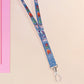 Cute full legth dark blue lanyard with a double sided cryptid monster and alien pattern and silver swivel hook clasp.