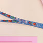 Cute full legth dark blue lanyard with a double sided cryptid monster and alien pattern and silver swivel hook clasp.