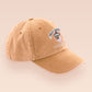 A vintage yellow baseball cap hat with an embroidered cute goose wearing a paper hat with the quote Silly Goose University