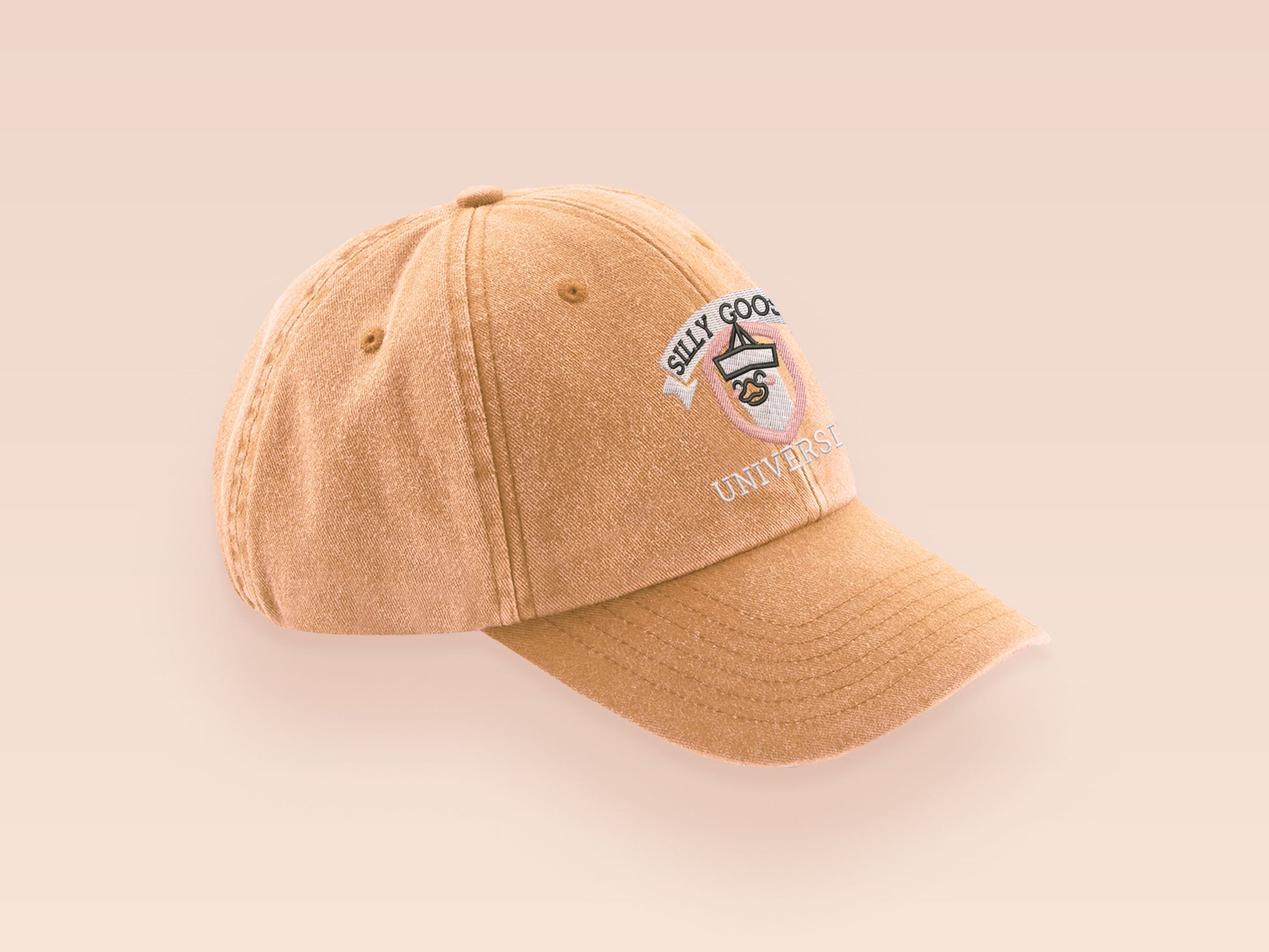 A vintage yellow baseball cap hat with an embroidered cute goose wearing a paper hat with the quote Silly Goose University