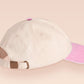 Vintage style truckers baseball cap with a contrast cream and pink peak design with an embroidered cute hanster angry and sulking with the quote smol but angy