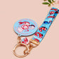 Acrylic epoxy shrimp keychain with a large acrylic charm of a a chef shrimp frying rice in a pan with the quote so you're telling me a shrimp fried this rice, a smaller charm of a cute baby shrimp and a matching blue shrimp lanyard.
