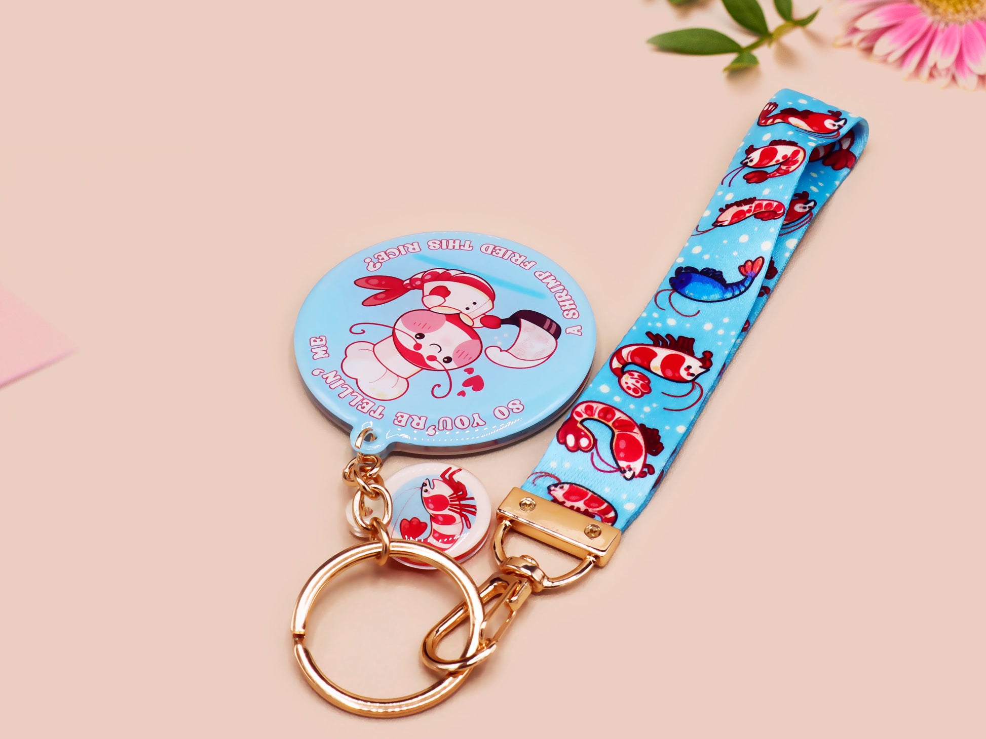 Acrylic epoxy shrimp keychain with a large acrylic charm of a a chef shrimp frying rice in a pan with the quote so you're telling me a shrimp fried this rice, a smaller charm of a cute baby shrimp and a matching blue shrimp lanyard.