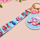 Acrylic epoxy shrimp keychain with a large acrylic charm of a a chef shrimp frying rice in a pan with the quote so you're telling me a shrimp fried this rice, a smaller charm of a cute baby shrimp and a matching blue shrimp lanyard.