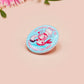 A clear acrylic pin badge with a pink heart-shaped pin back clasp. The design of the pin badge is of a cute chibi shrimp in a chefs outfit cooking with the quote So you're telling me a shrimp fried this rice?