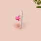 A clear acrylic pin badge with a pink heart-shaped pin back clasp. The design of the pin badge is of a cute chibi shrimp in a chefs outfit cooking with the quote So you're telling me a shrimp fried this rice?