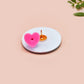 A clear acrylic pin badge with a pink heart-shaped pin back clasp. The design of the pin badge is of a cute chibi shrimp in a chefs outfit cooking with the quote So you're telling me a shrimp fried this rice?