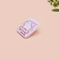 Clear acrylic pin badge with a pink heart-shaped rubber pin back clasp. The design of the pin badge is a cute chibi white cat skateboarding with the quote some people are just too cool but not me.