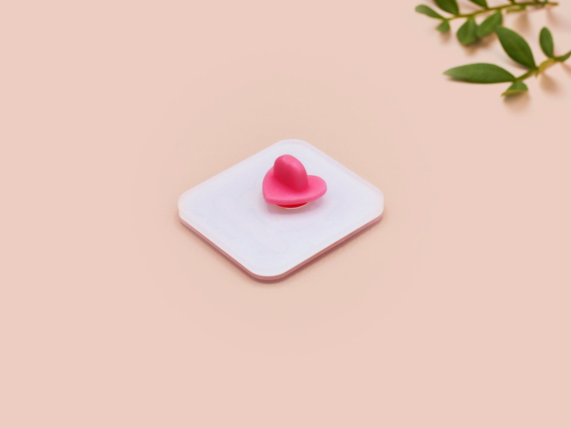 Clear acrylic pin badge with a pink heart-shaped rubber pin back clasp. The design of the pin badge is a cute chibi white cat skateboarding with the quote some people are just too cool but not me.