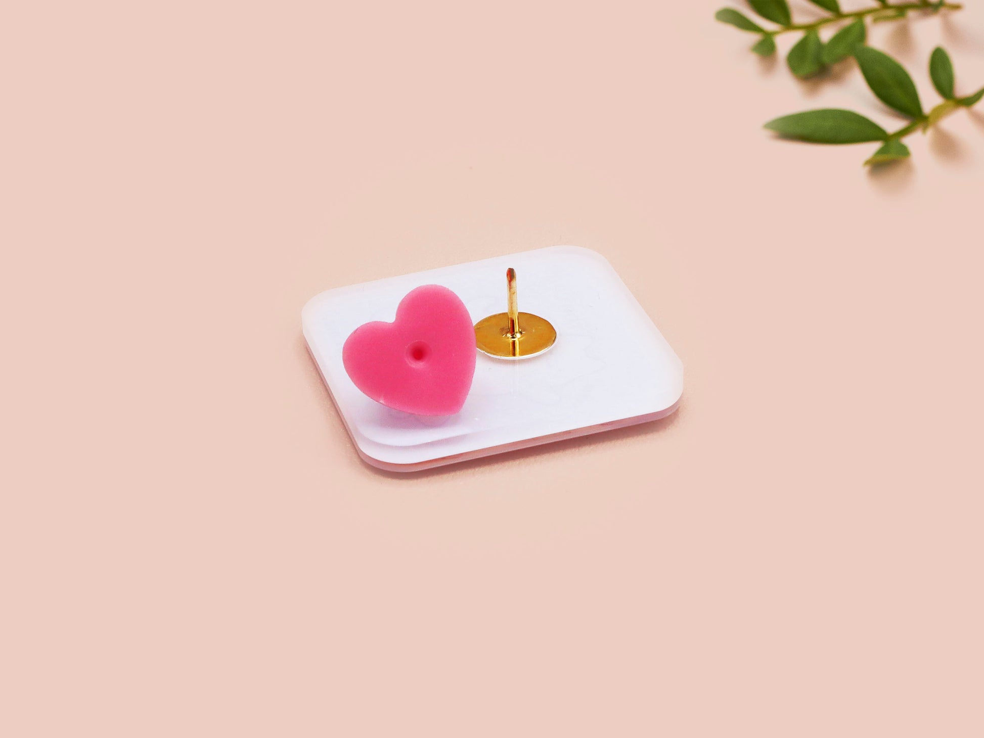 Clear acrylic pin badge with a pink heart-shaped rubber pin back clasp. The design of the pin badge is a cute chibi white cat skateboarding with the quote some people are just too cool but not me.