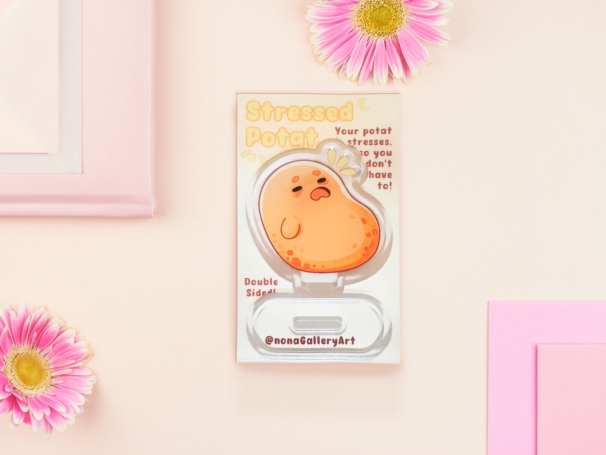 An acrylic double-sided standee desk budy featuring a cute cartoon chibi potato with a stressed expression.