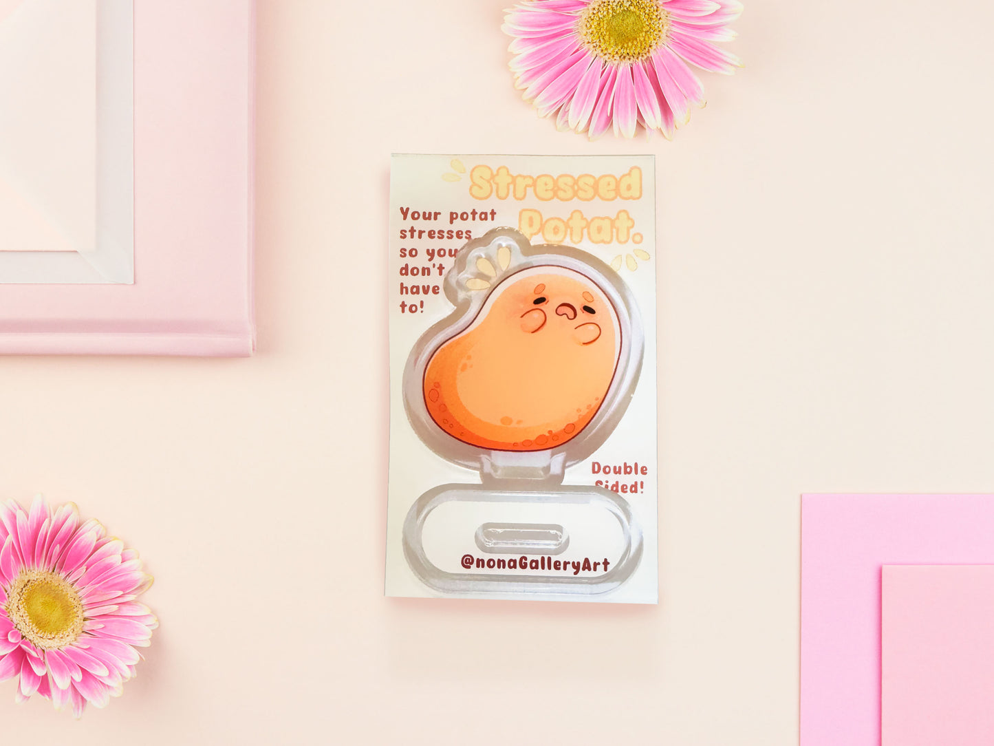 An acrylic double-sided standee desk budy featuring a cute cartoon chibi potato with a stressed expression.