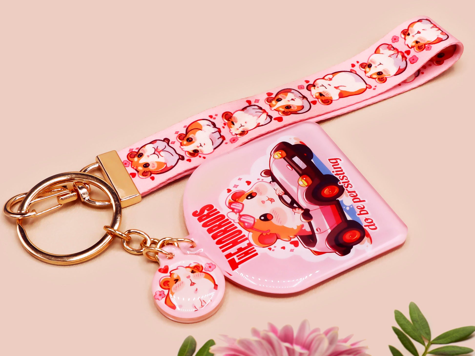 Cute pink keychain and lanyard of an adorable chibi hamster guinea pig in heart sunglasses driving a little pink car with the quote the Horrors do be persisting, with matching mini charm and lanyard of multiple cute fat guinea pig hamsters