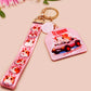 Cute pink keychain and lanyard of an adorable chibi hamster guinea pig in heart sunglasses driving a little pink car with the quote the Horrors do be persisting, with matching mini charm and lanyard of multiple cute fat guinea pig hamsters