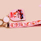 Cute pink keychain and lanyard of an adorable chibi hamster guinea pig in heart sunglasses driving a little pink car with the quote the Horrors do be persisting, with matching mini charm and lanyard of multiple cute fat guinea pig hamsters