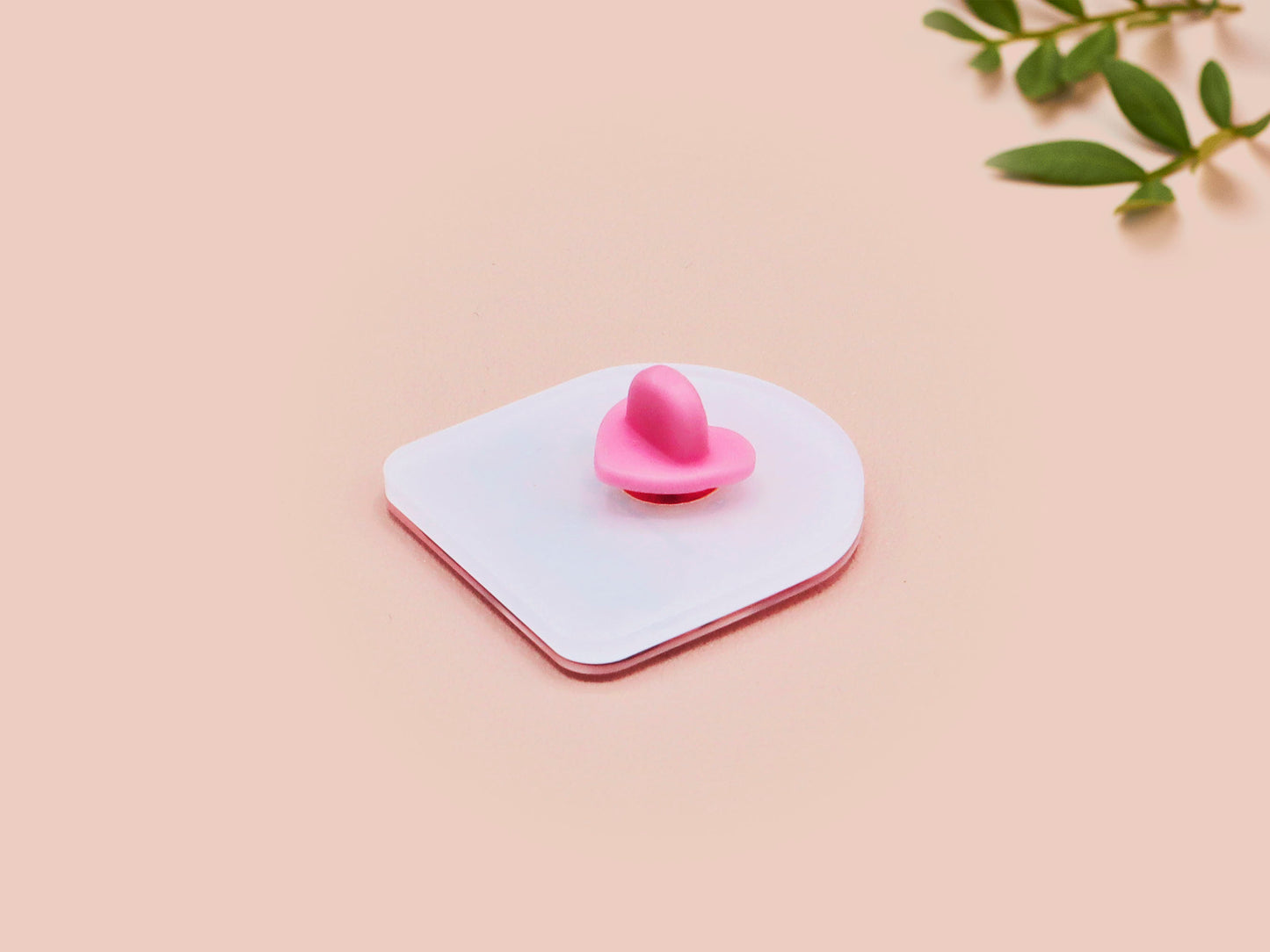 Clear acrylic pin badge with a pink heart-shaped rubber pin back clasp. The design of the pin badge is a cute chibi guinea pig hamster driving a pink car and the quote the horrors do be persisting.