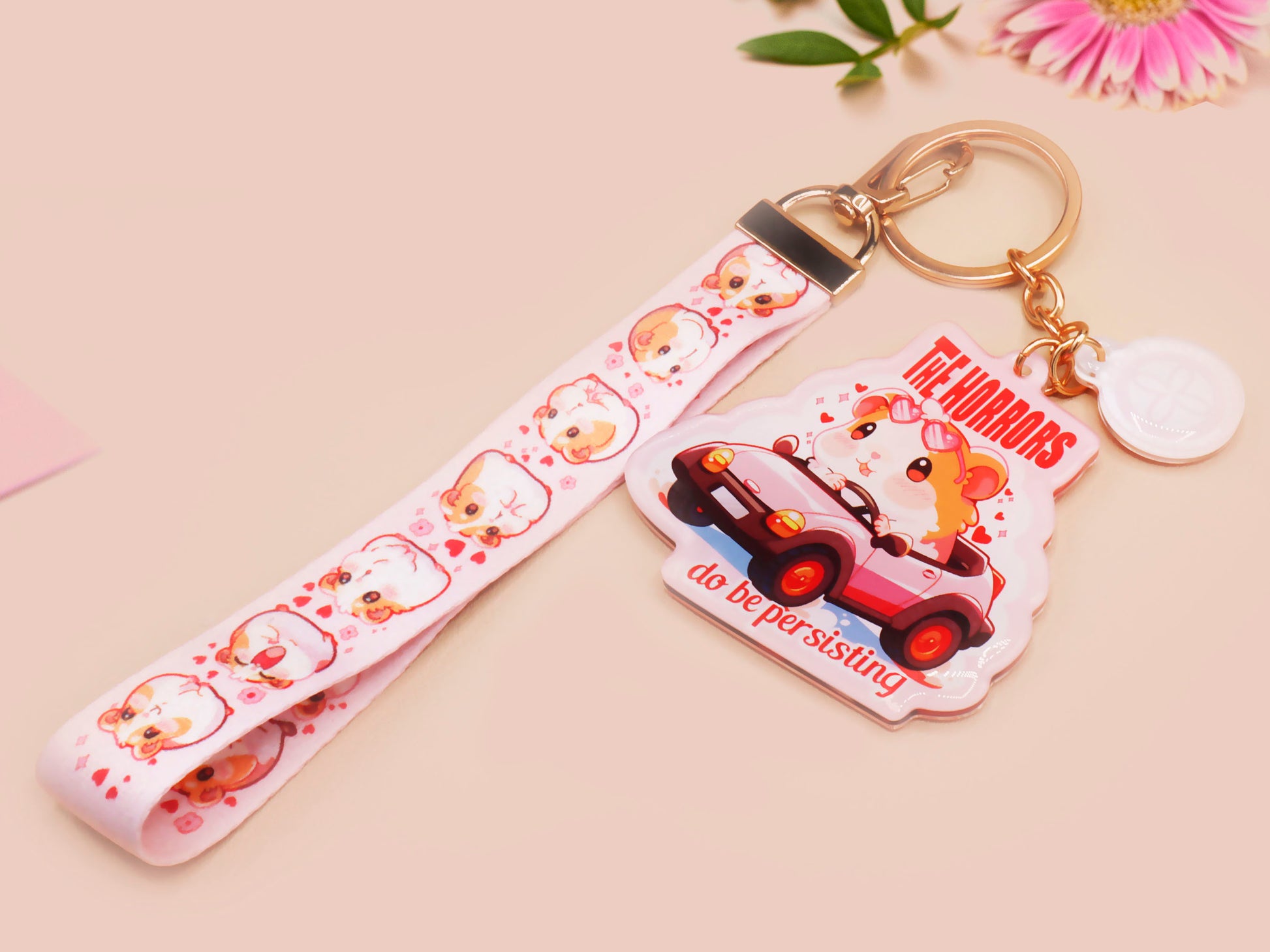 Cute pink keychain and lanyard of an adorable chibi hamster guinea pig in heart sunglasses driving a little pink car with the quote the Horrors do be persisting, with matching mini charm and lanyard of multiple cute fat guinea pig hamsters