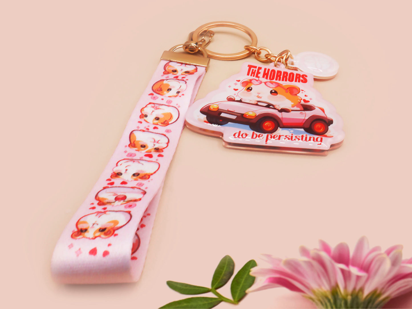 Cute pink keychain and lanyard of an adorable chibi hamster guinea pig in heart sunglasses driving a little pink car with the quote the Horrors do be persisting, with matching mini charm and lanyard of multiple cute fat guinea pig hamsters