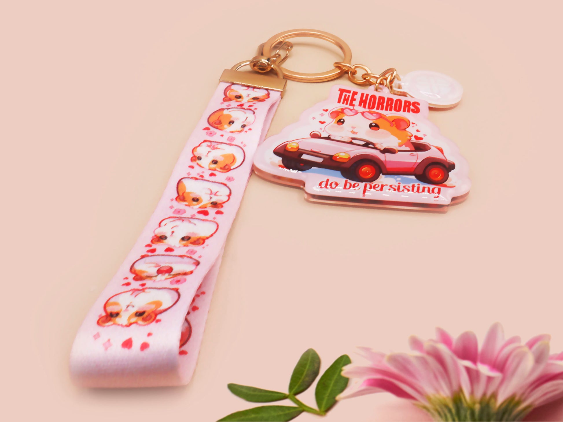 Cute pink keychain and lanyard of an adorable chibi hamster guinea pig in heart sunglasses driving a little pink car with the quote the Horrors do be persisting, with matching mini charm and lanyard of multiple cute fat guinea pig hamsters