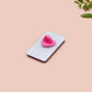 A black acrylic pin badge with a pink heart-shaped pin back clasp. The design of the pin badge is of a cute goose in a shirt and tie with the quote Time For Serious Goose