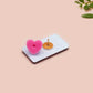 A black acrylic pin badge with a pink heart-shaped pin back clasp. The design of the pin badge is of a cute goose in a shirt and tie with the quote Time For Serious Goose