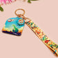 Acrylic epoxy dinosaur keychain with a large acrylic charm of a long necked dinosaur looking up at an incoming asteroid with the quote uh oh, a smaller charm of a cute trex with arm grabbers and a matching hatching baby dinosaur lanyard.