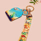 Acrylic epoxy dinosaur keychain with a large acrylic charm of a long necked dinosaur looking up at an incoming asteroid with the quote uh oh, a smaller charm of a cute trex with arm grabbers and a matching hatching baby dinosaur lanyard.