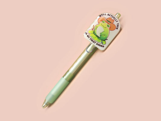 Green ballpoint pen with black ink and a cute chibi cowboy frog design.