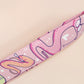 Cute full legth pink lanyard with a double sided funny worm on a string pattern and silver swivel hook clasp.