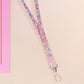 Cute full legth pink lanyard with a double sided funny worm on a string pattern and silver swivel hook clasp.