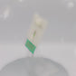 Video of the front and back of the Gold Enamel Talisman Charm the words Mini Talisman sits on a long white and green backing card with gold accents. The backing card has details the symbolism of the different design elements of the Talisman pin.