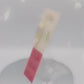 Video of the front and back of the Gold Enamel Talisman Pin with mini charm and the words Pet Owner's Talisman sits on a long white and pink backing card with gold accents. The backing card has details the symbolism of the different design elements of the Talisman pin.