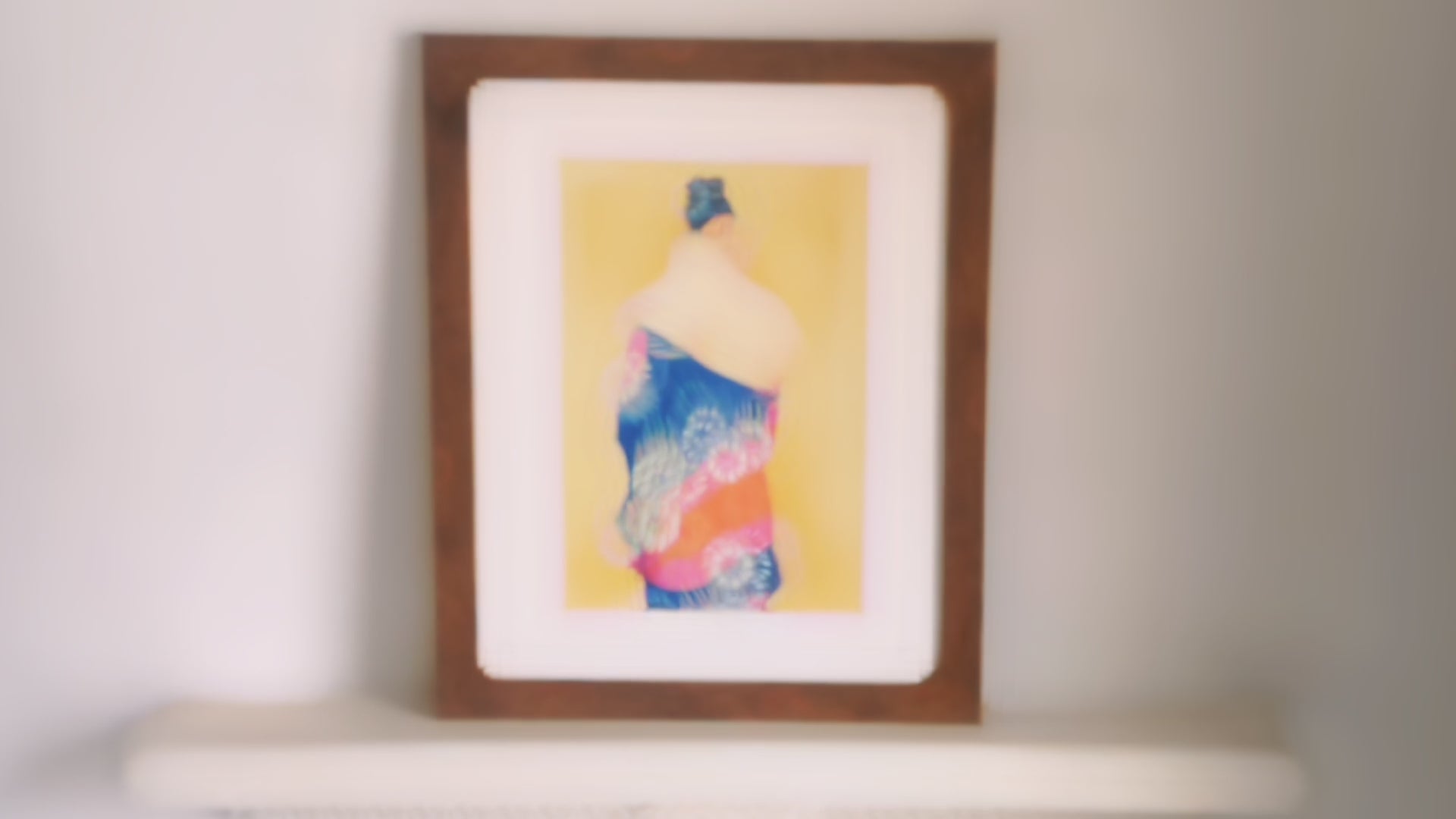 Video of brown framed oil painting with white frame mount. The painting itself is of a woman facing away wearing a blue iris kimono.