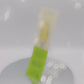 Video showing the front and back of the Gold Enamel Talisman Pin with yellow design and the words Mother's Talisman sits on a long white and green backing card with gold accents. The backing card has details the symbolism of the different design elements of the Talisman pin.