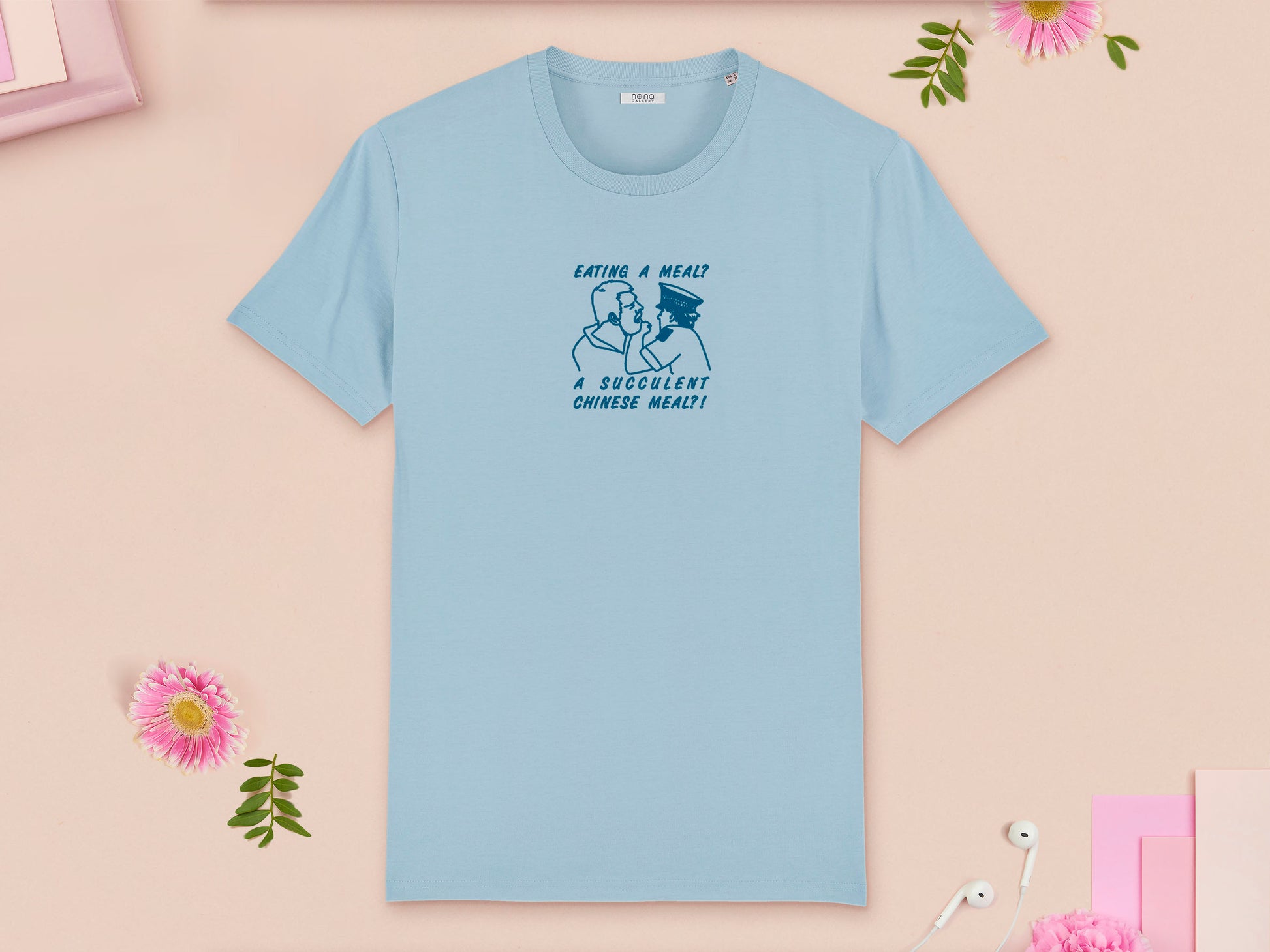 A blue crew neck short sleeve t-shirt, with an embroidered blue thread design of the viral democracy manifest video of Charles Dozsa being arrested by a policeman with the text reading Eating A Meal? A Succulent Chinese Meal?!