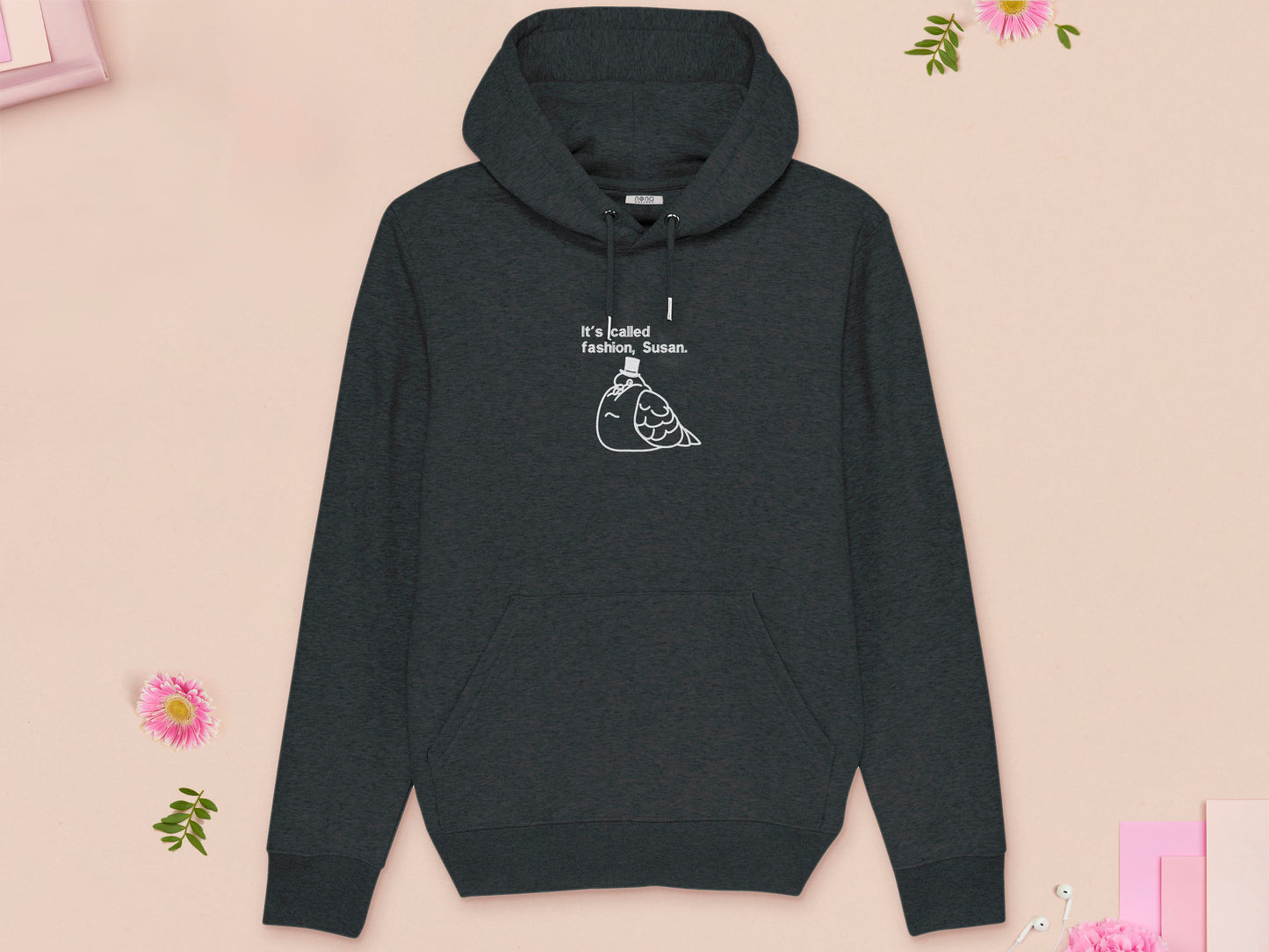 A grey long sleeve fleece hoodie, with an embroidered white thread design of cute fat pigeon wearing a top hat with text underneath reading It's Called Fashion, Susan.