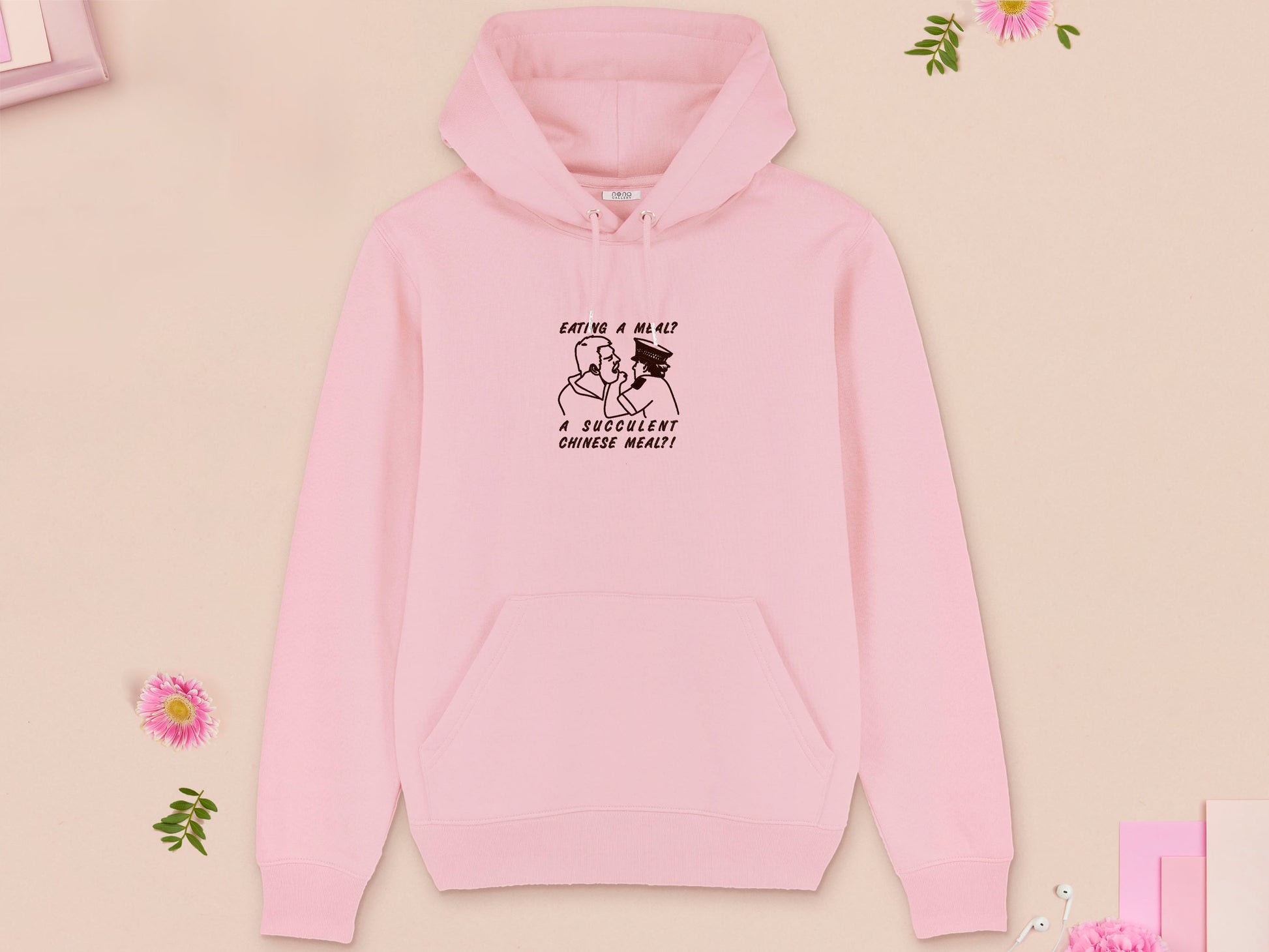 A pink long sleeve fleece hoodie, with an embroidered brown thread design of the viral democracy manifest video of Charles Dozsa being arrested by a policeman with the text reading Eating A Meal? A Succulent Chinese Meal?!