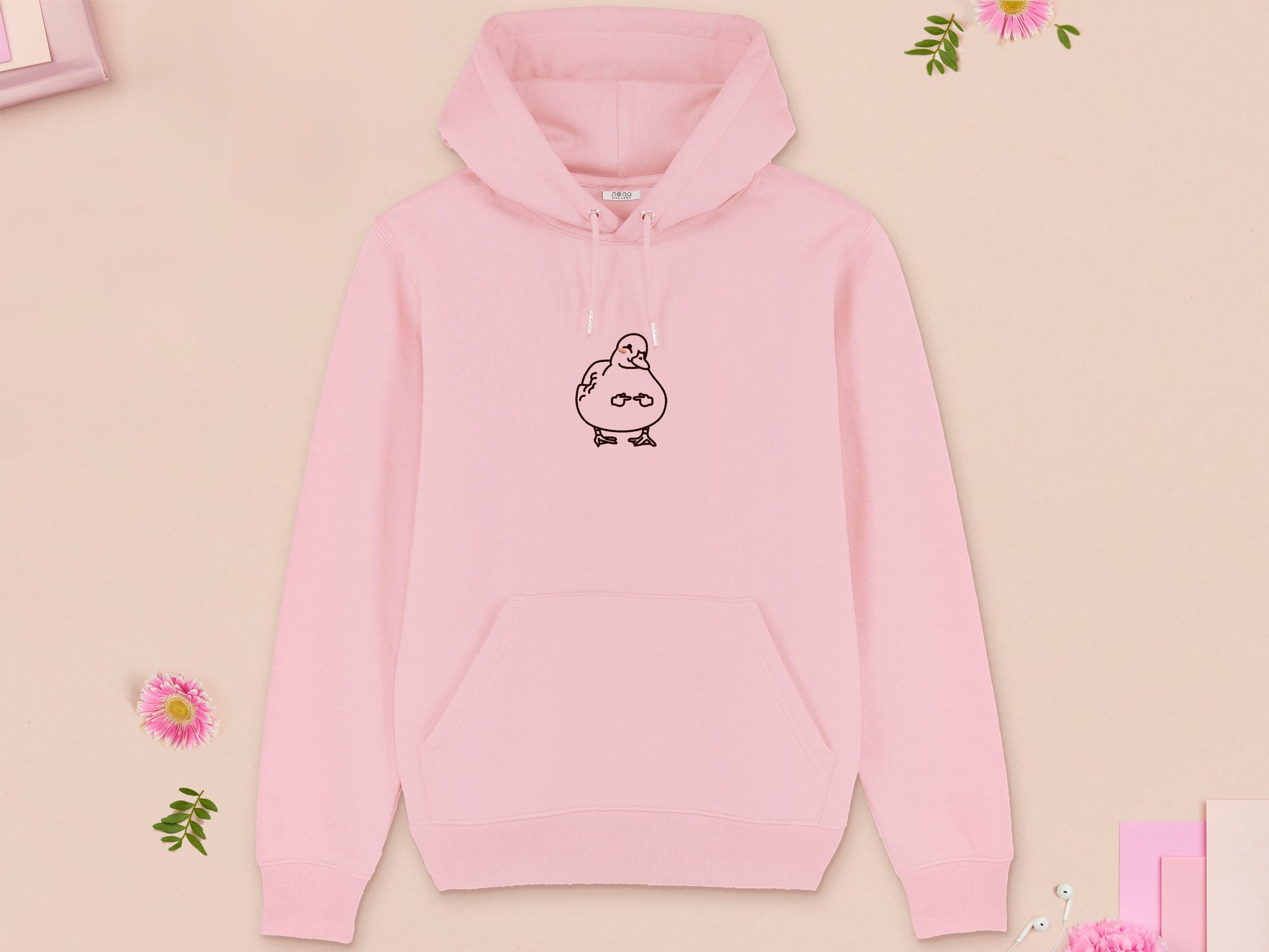A pink long sleeve fleece hoodie, with an embroidered brown thread design of cute blushing duck with the for me finger hand emoji symbols