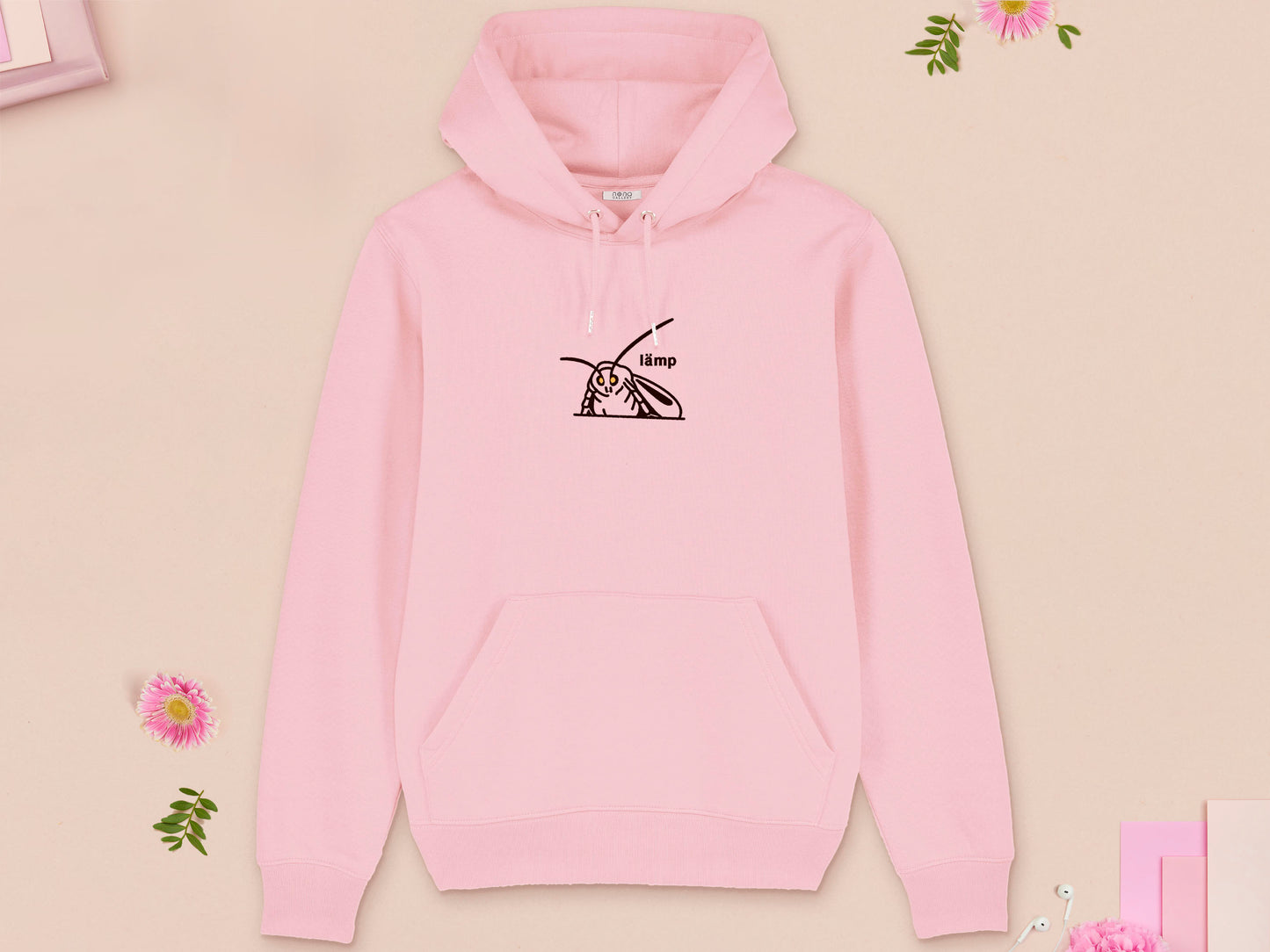 A pink long sleeve fleece hoodie, with an embroidered brown thread design of a moth with glowing yellow eyes and the word lämp