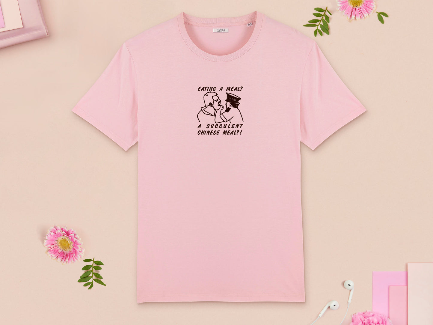 A pink crew neck short sleeve t-shirt, with an embroidered brown thread design of the viral democracy manifest video of Charles Dozsa being arrested by a policeman with the text reading Eating A Meal? A Succulent Chinese Meal?!